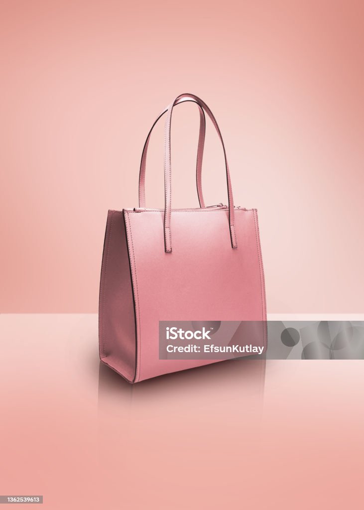 Fashion photography, pink color tote bag on a pastel pink background with clipping path Cut out image of a studio shot pink color tote bag isolated on pink background Purse Stock Photo