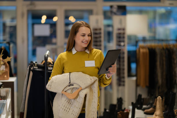 istock Woman using a digital tablet and sorting clothes in the store 1362539813