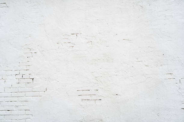 istock Abstract textured background of old white brick wall with plaster 1362540351