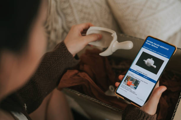 istock unhappy asian chinese woman complaining using mobile app on received broken teapot from online shopping a living room 1362540867