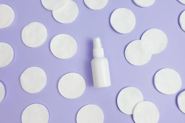 top view and close-up of white plastic spray bottle mock-up and cotton pads pattern on purple background. top view, flatlay, lifestyle. clean beauty and liquid antimicrobial spray concept. - liquid soap blue plastic textile imagens e fotografias de stock