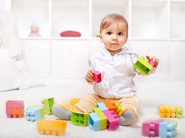 istock Cute little baby playing with colorful blocks 136254497