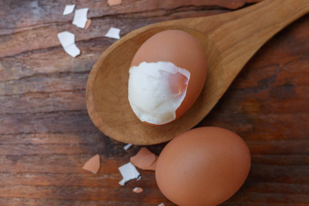 istock Boiled eggs with shells removed on a wooden spoon 1362546247