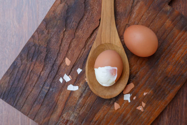 istock Boiled eggs with shells removed on a wooden spoon 1362546248