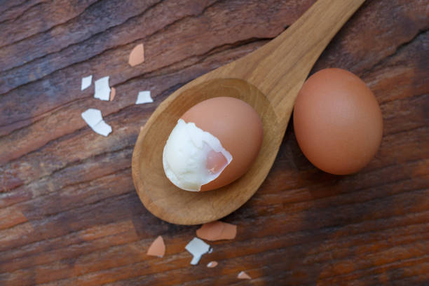 istock Boiled eggs with shells removed on a wooden spoon 1362546250