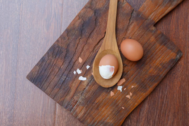 istock Boiled eggs with shells removed on a wooden spoon 1362546251