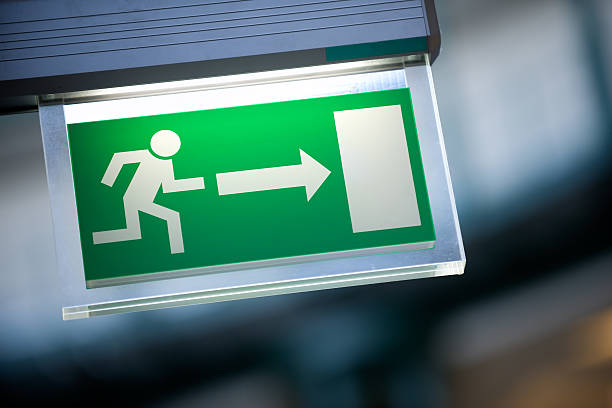 Close-up of green emergency exit light sign fire exit light sign exit sign photos stock pictures, royalty-free photos & images