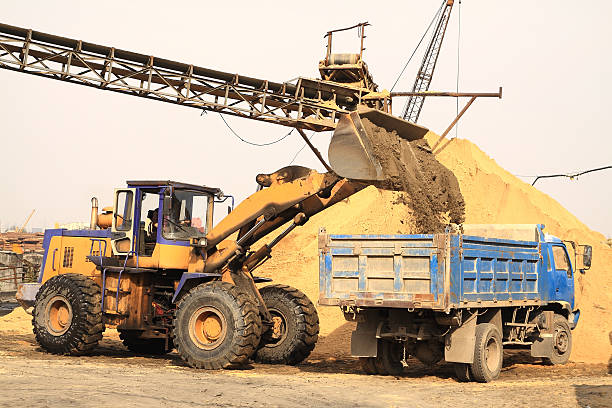 istock Excavator loading blue truck in the yard 136254730