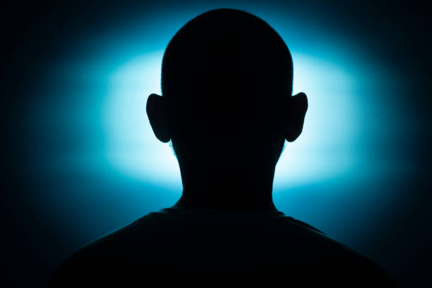 istock Close-up silhouette of a man's head against a blue background. 1362549191