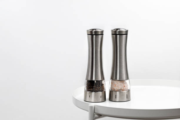 istock Two electric spice mills for salt and pepper. Metal. On a white table 1362549317