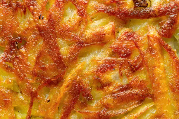 close up of golden swiss rosti potato pancake food background