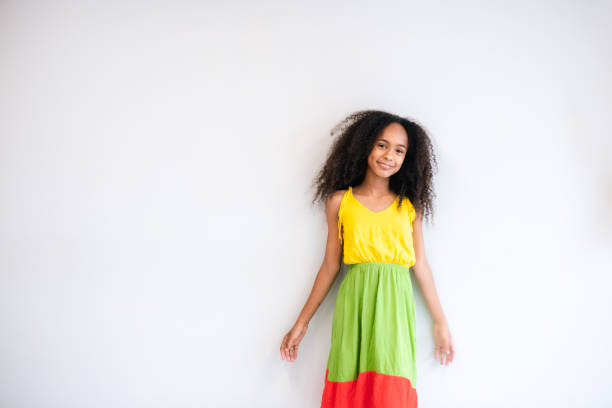 Young black woman, with African descent, happy. Girl portrait with white background.