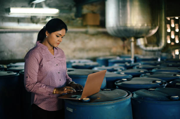 istock Woman using laptop in a factory 1362553183