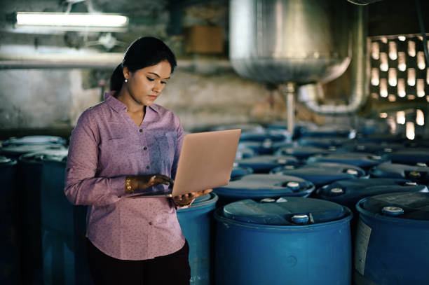 istock Woman using laptop in a factory 1362553744