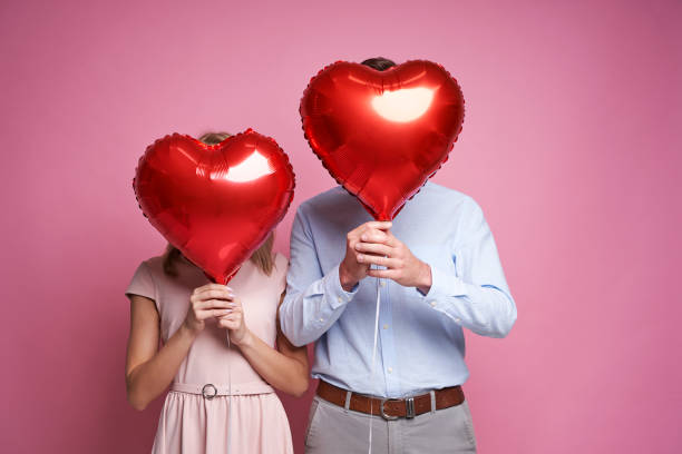 istock A couple hidden behind a heart shape balloons 1362553985