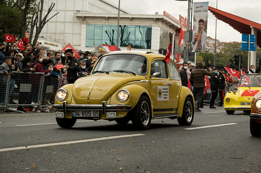 Istanbul, Turkey - October 29, 2021: A yellow 1963 Volkswagen Beetle parade on October 29 republic day of Turkey, Classic car parade moment.