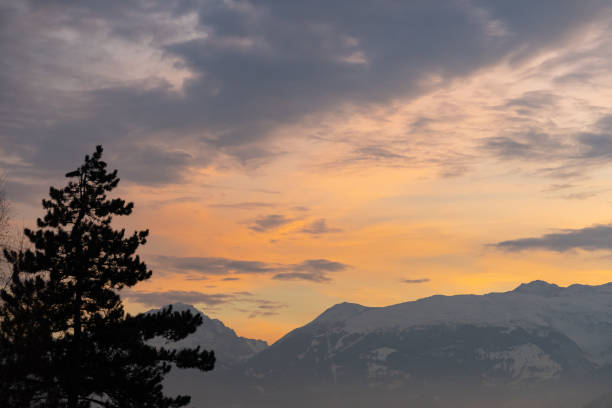 Vaduz, Liechtenstein, December 14, 2021 Majestic cloud scenery after sunset over the mountains