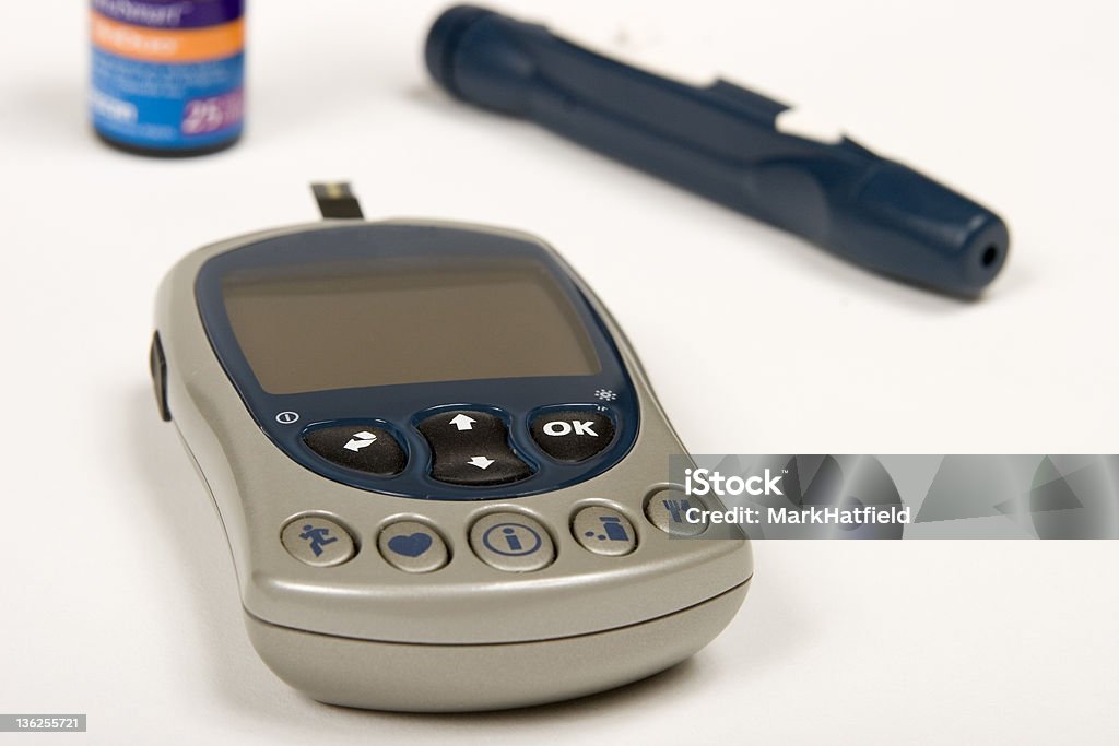 Glucometer, lancet and test strip bottle A diabetes Glucometer, lancet and test strip bottle.  Focus is on keys for glucometer. http://www.theotterchalet.com/istock/glucosemonitorscloseup.jpg Blood Sugar Test Stock Photo