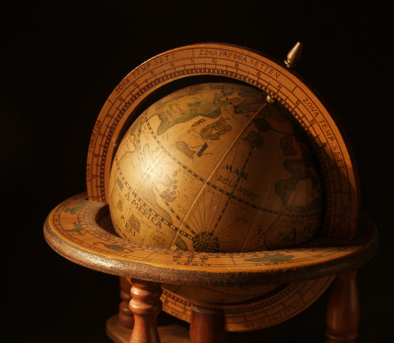 An antique globe on a black background.