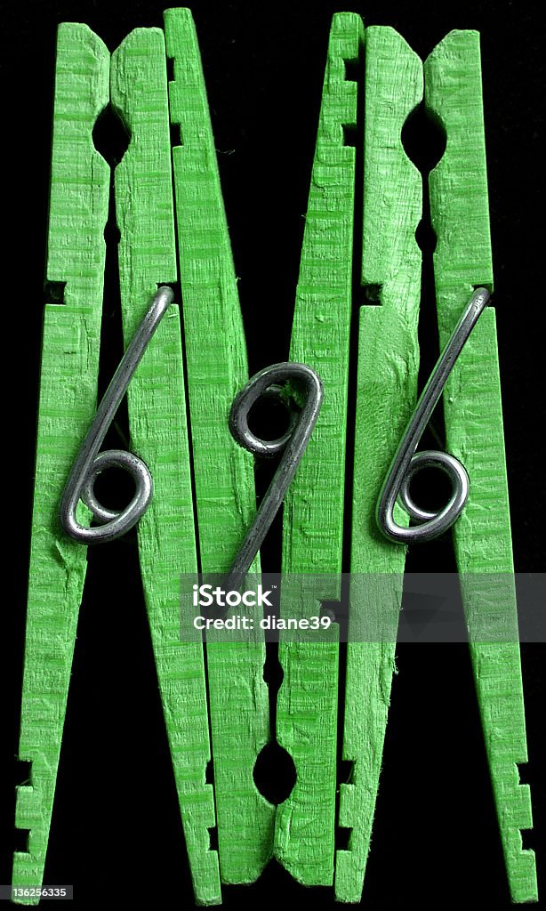 green clothespins three green clothespins. Abstract Stock Photo
