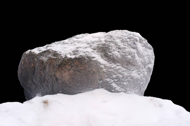 istock natural stone in snow isolated on black background 1362563769
