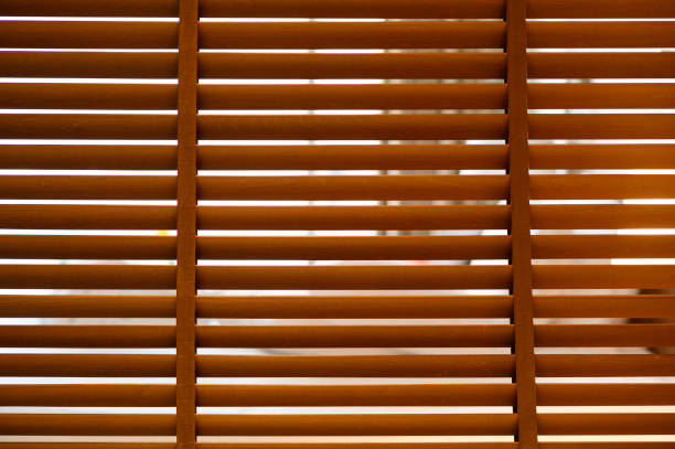 istock open wooden venetian blinds. lighting range control sunlight coming from a window. decoration interior. Modern jalousie. 1362566995