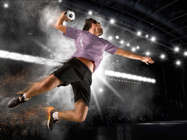 Caucasian young handball player in action Caucasian young handball player in action. Concept of sport, movement, energy, dynamic, team handball stock pictures, royalty-free photos & images