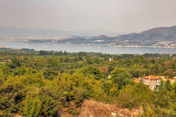 Morning view over Polyfytos artificial lake, Servia Neraida bridge and Velventos village. Larissa, Greece.
