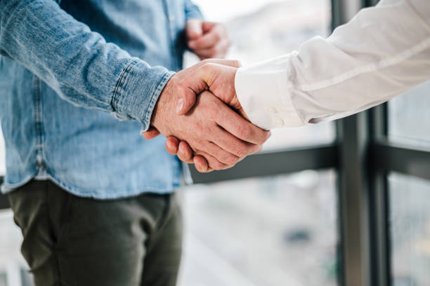 Close up shot of teamwork handshake in the office businessman entrepreneur freelancer shaking hands for successful negotiations and company business merger and acquisition Close up shot of teamwork handshake in the office businessman entrepreneur freelancer shaking hands for successful negotiations and company business merger and acquisition symbiotic relationship stock pictures, royalty-free photos & images