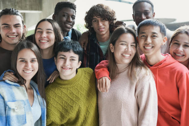 istock Group of happy multracial students smiling on camera 1362570209