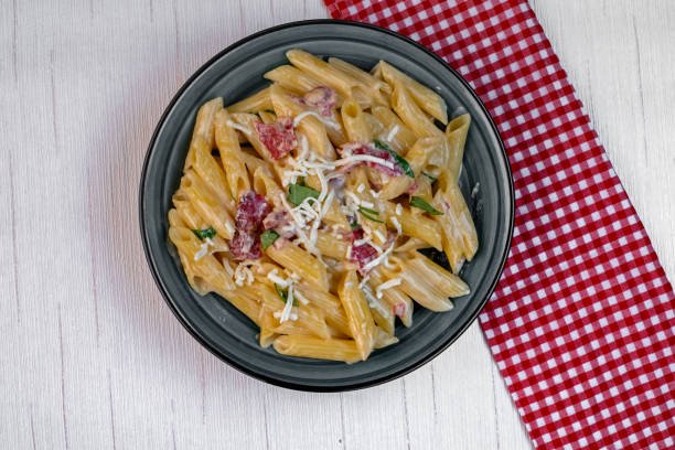 istock Penne pasta with tomato sauce and parmesan cheese 1362570935