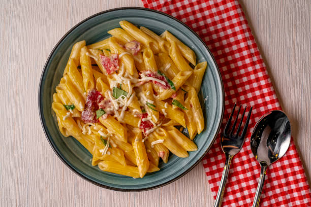 istock Penne pasta with tomato sauce and parmesan cheese 1362571239