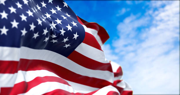 The national flag of the United States of America waving in the wind stock photo