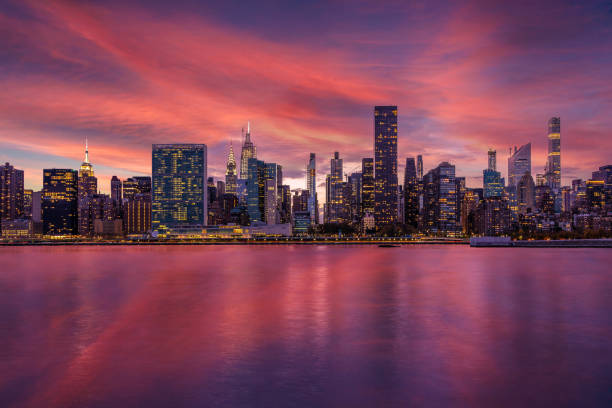 skyline di new york city con un edificio delle nazioni unite, un chrysler building, un empire state building e east river al tramonto. - midtown manhattan foto e immagini stock