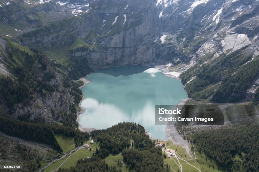 Blue lagoon in high mountain from aerial view Blue lagoon in high mountain from aerial view in Kandersteg, Canton of Bern, Switzerland Adventure Stock Photo