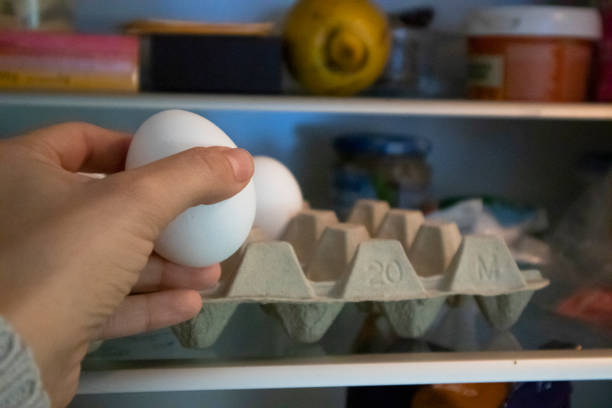 istock Woman picking up eggs from the refrigerator 1362577004