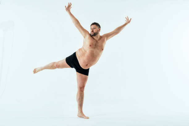 Man posing for a male edition body positive beauty set. Shirtless guy wearing boxers underwear in studio Overweight man posing for a male edition body positive beauty set. Shirtless guy wearing boxers underwear in studio fat guy no shirt stock pictures, royalty-free photos & images