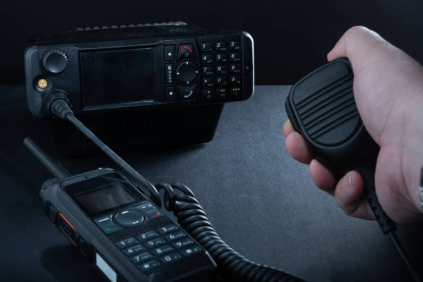 Closeup of pair of mobile two-way radios for Amateur radio operators against dark background. stock photo