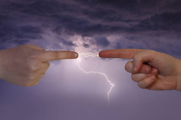 two human fingers point and exchange lightning bolts