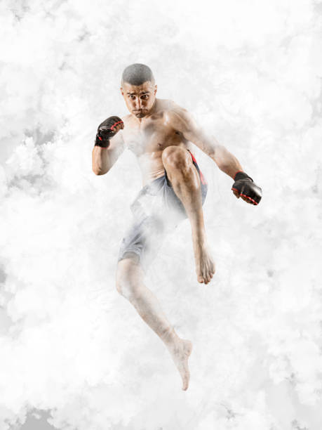 istock MMA male fighter. White smoke background 1362584152
