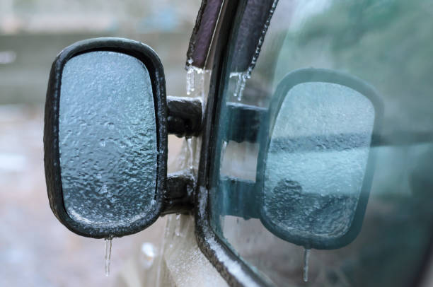 istock Freezing of ice on the car mirror during atmospheric icing. 1362584344