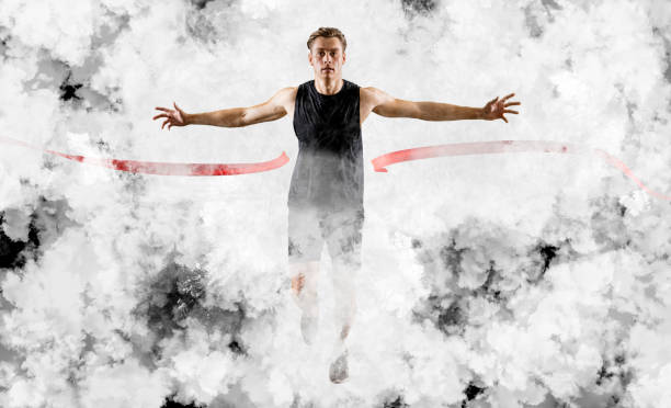 istock Runner wins by crossing the finish line on white smoke background 1362584660