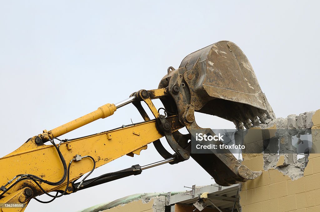 Pulling the Wall Tracked Excavator removing a wall on a major remodel of a chain department store. Backhoe Stock Photo