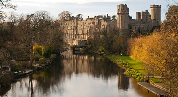 Warwick Castle,England Autumn colours at Warwick castle on the river Avon,England warwick uk stock pictures, royalty-free photos & images