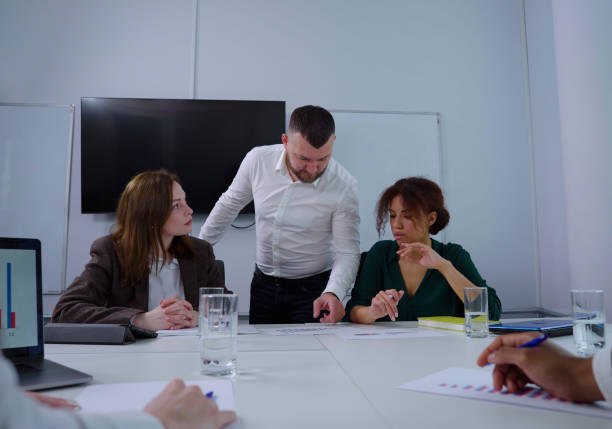 istock Team leader discussing business report with group 1362587014