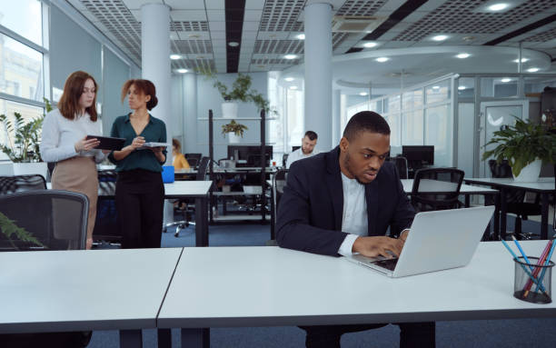 istock African American businessman using laptop in open space office 1362587094