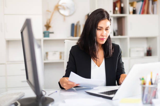 istock Tired businesswoman working with documents in office 1362587766
