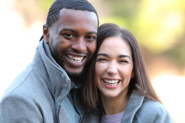 istock Happy interracial couple laughing at camera in winter 1362588063