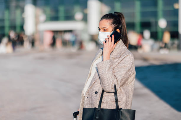 istock Young woman using smart phone while waiting for bus 1362589675