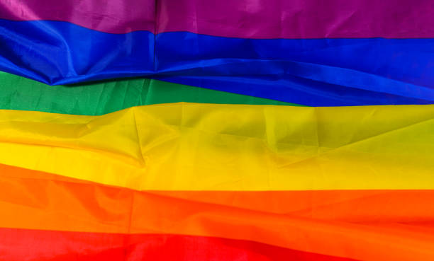 istock Rainbow flag on colorful fabric 1362590660